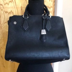 Black purse with silver hardware. Includes shoulder strap